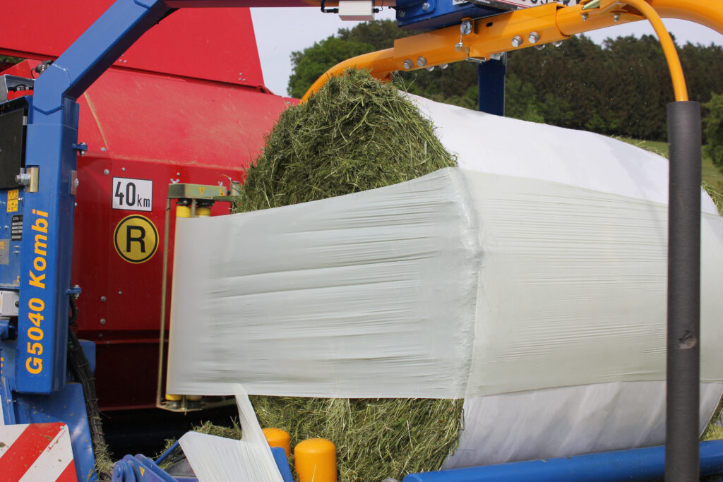 Baling silage using net replacement film for enhanced oxygen barrier protection