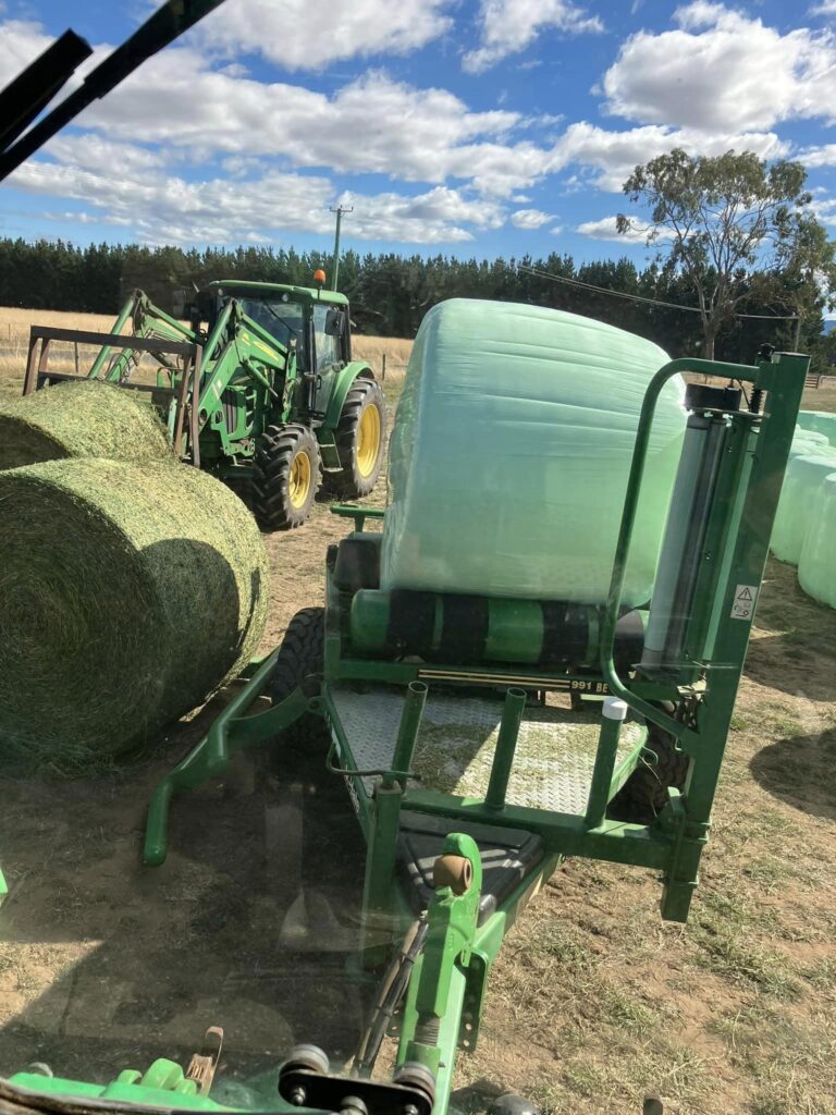 Bale being wrapped with silage plastic for UV protection, oxygen barrier and quality silage.