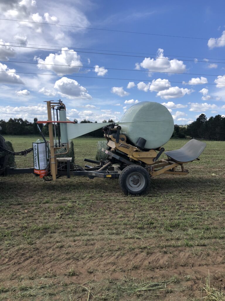 SiloPower 25 wrapping a silage bale with durable plastic for quality silage preservation.